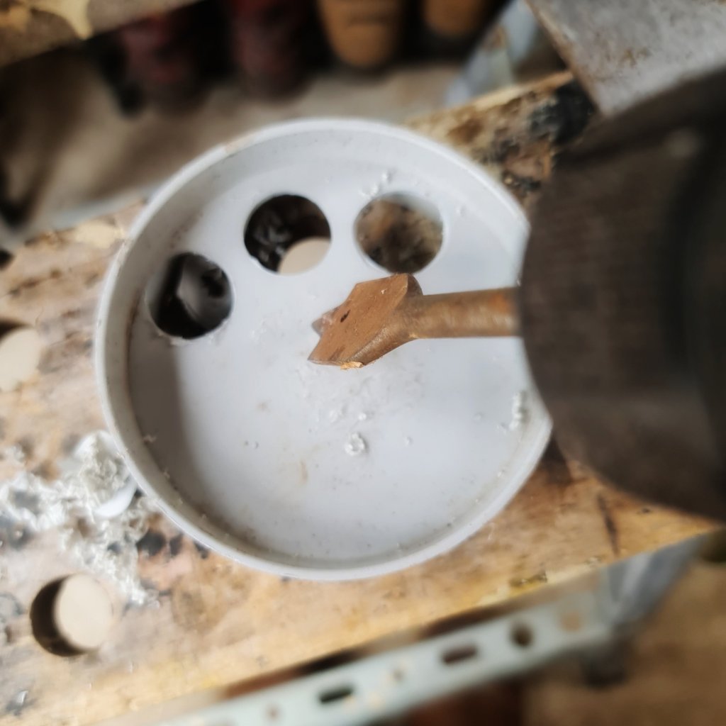 I used  a spade bit to cut out most of the center of the fitting